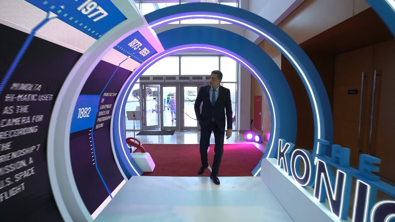 A guest walking out of the lit arch tunnel.