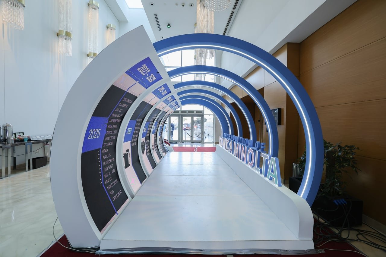 The tunnel of lit arches carrying a Konica Minolta timeline, before doors opened.