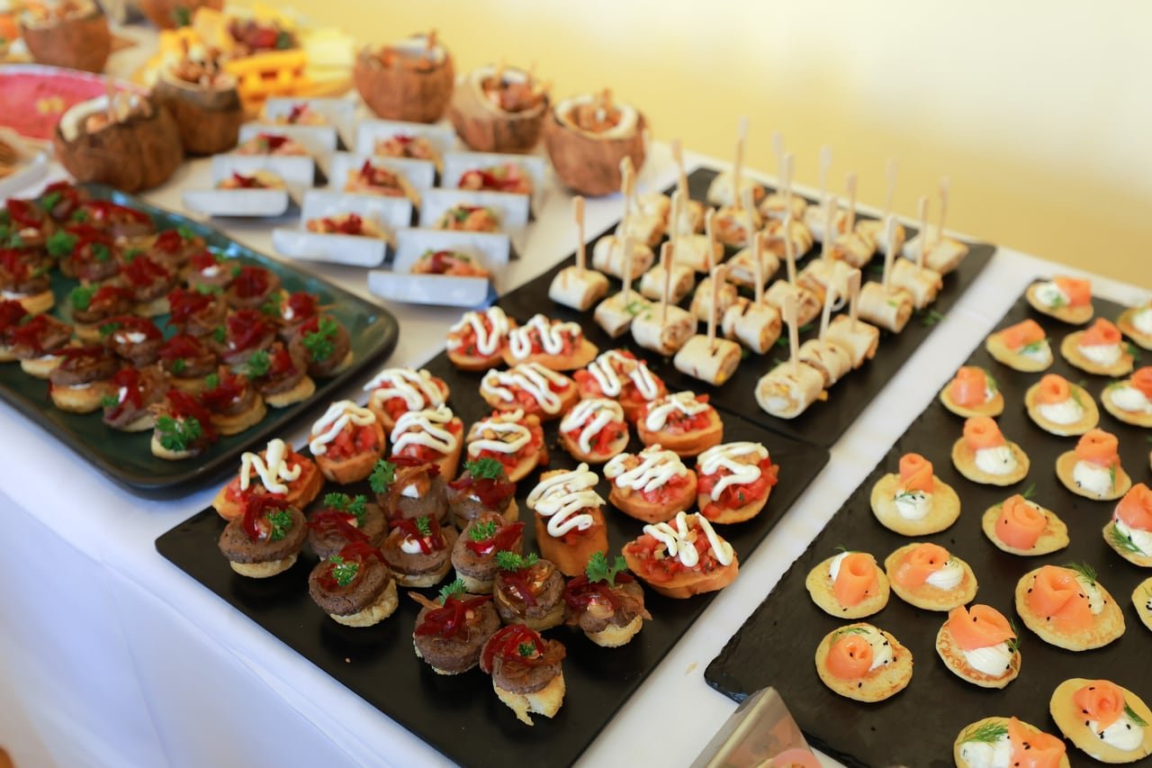 Trays of canapés, shot close in warm light.