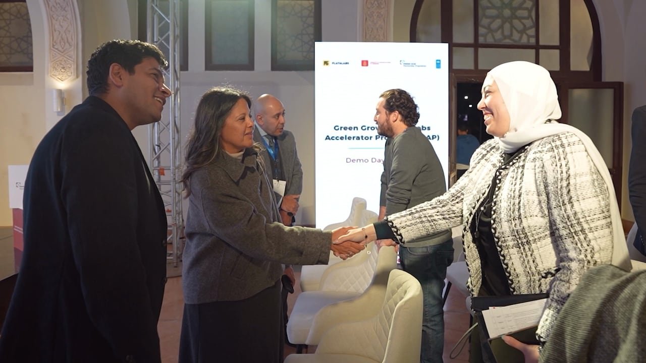 A handshake between guests in the foyer.