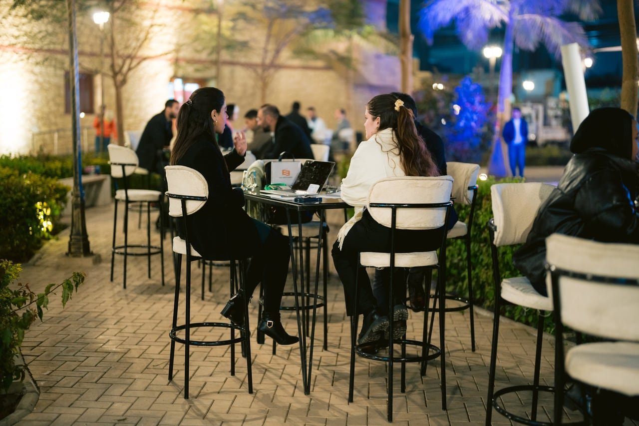 Meetings still going at the high tables after dark.