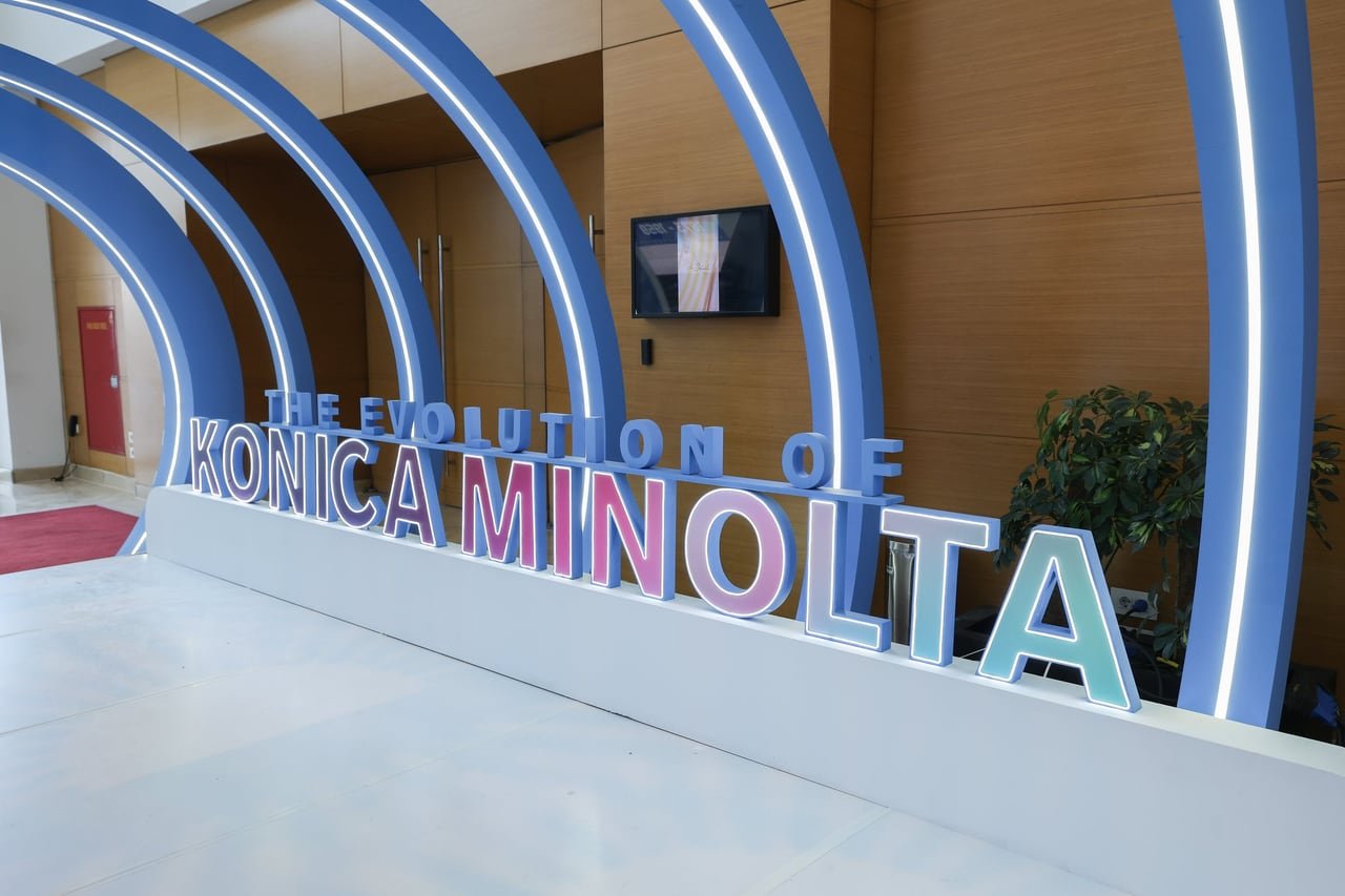 "The Evolution of Konica Minolta" lettering at the end of the tunnel.