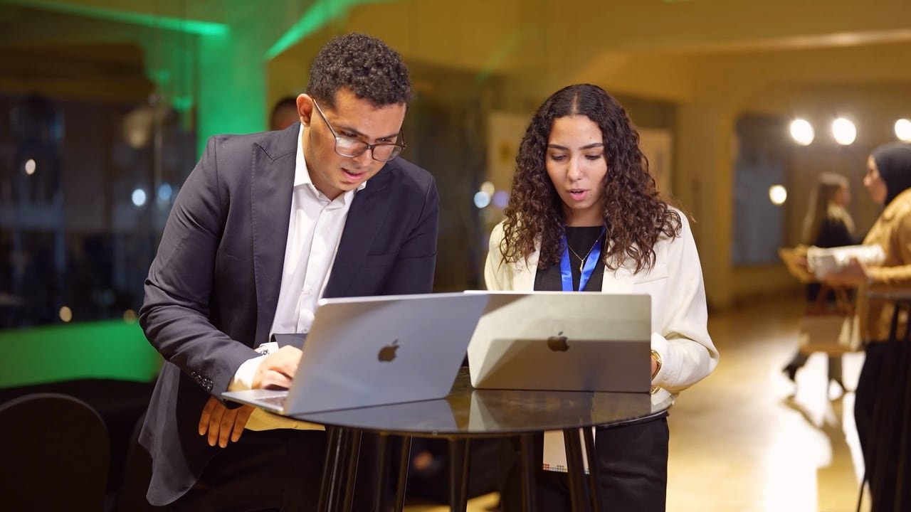 Two founders preparing at a laptop.