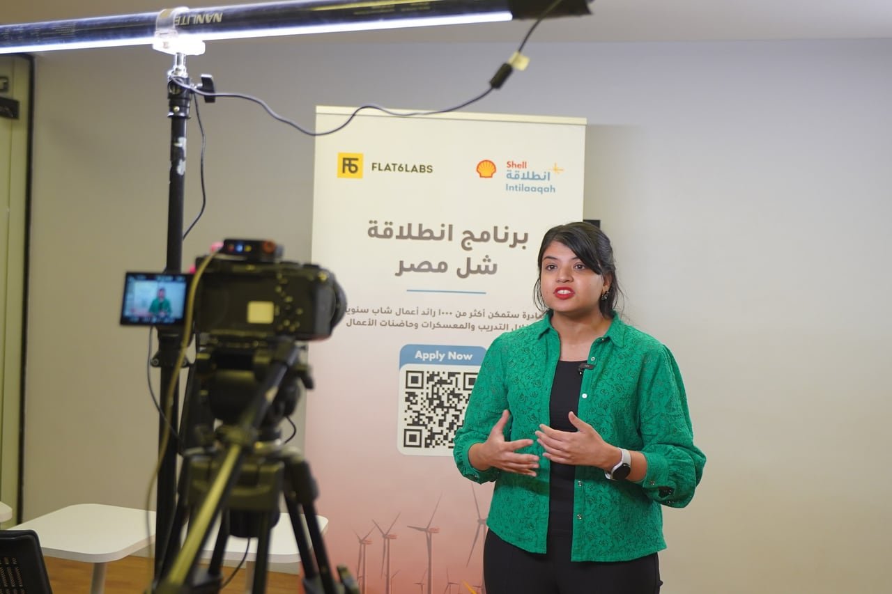 An interview being filmed in front of the Intilaaqah programme banner.