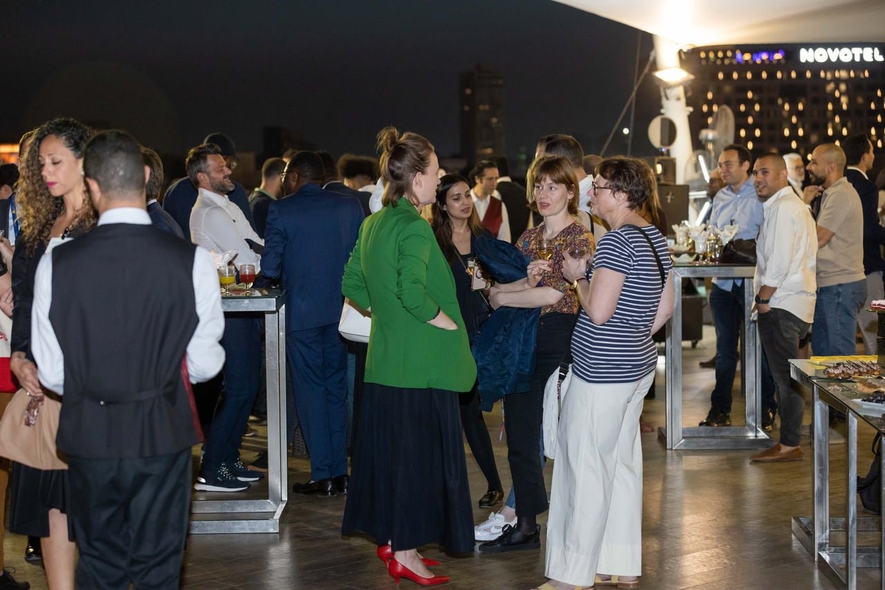 Guests talking on the terrace at night.