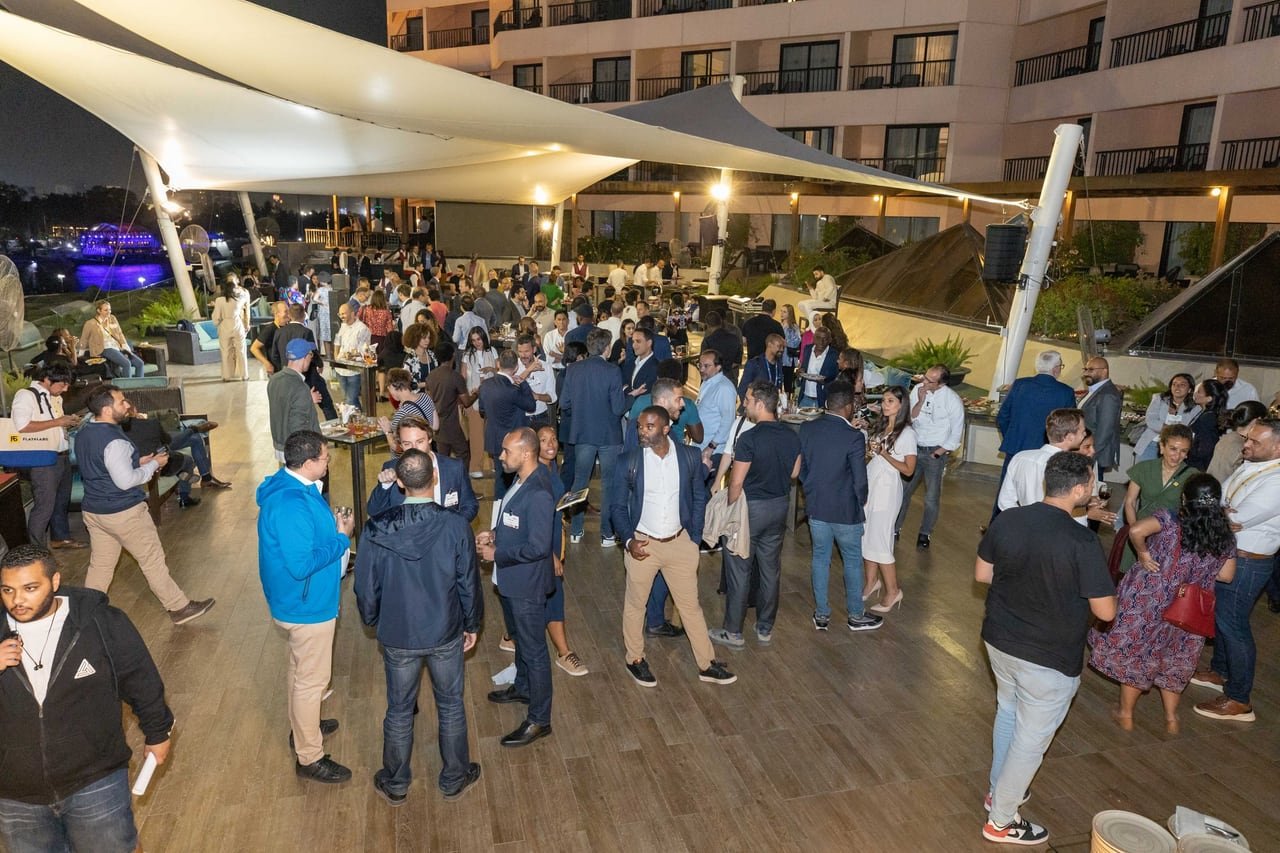 The rooftop full of guests under the white sails.