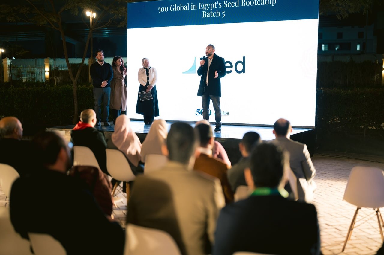 The audience watching a startup on stage.
