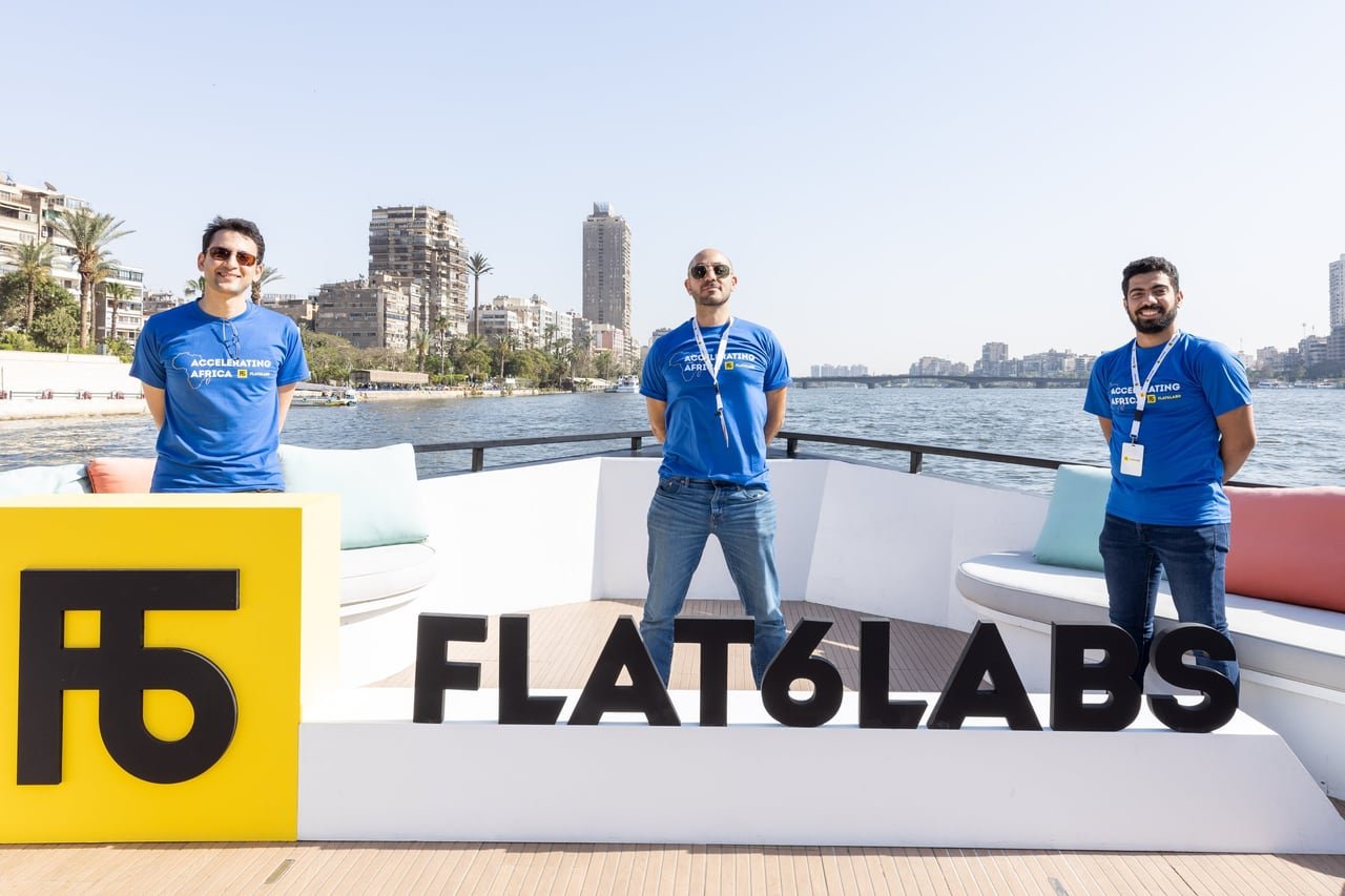 Three of the Flat6Labs team behind the giant F6 on deck.
