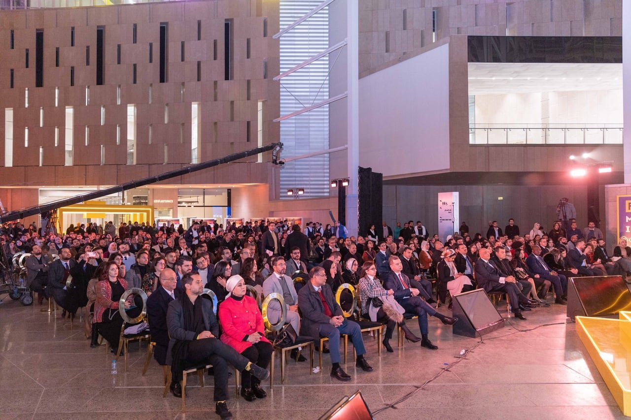 A full hall watching the stage at Cairo Demo Day, seen from above.