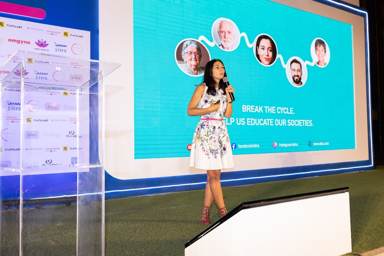 A founder presenting her startup on stage.
