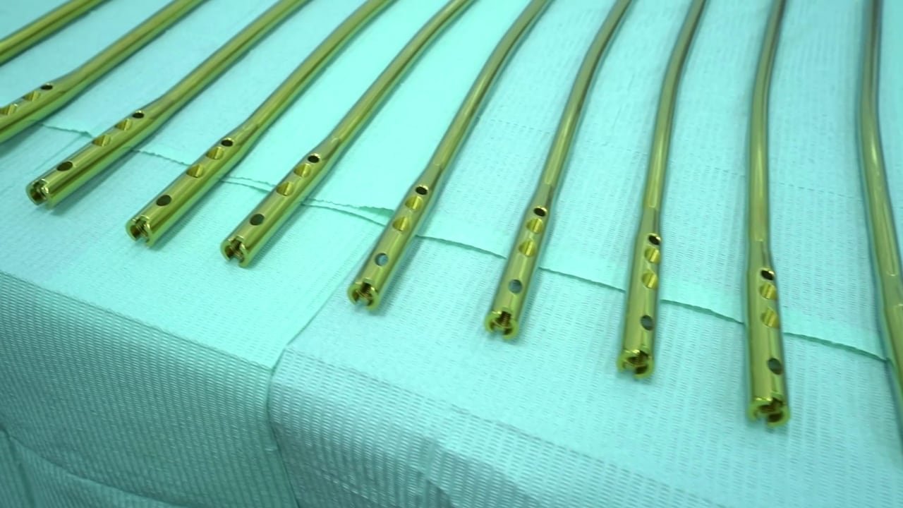 A row of green orthopaedic nails on a sterile sheet.