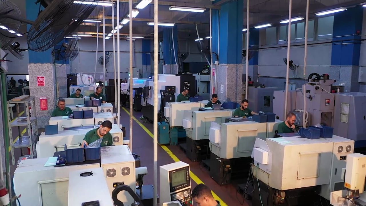 Operators at their machines on the production floor.