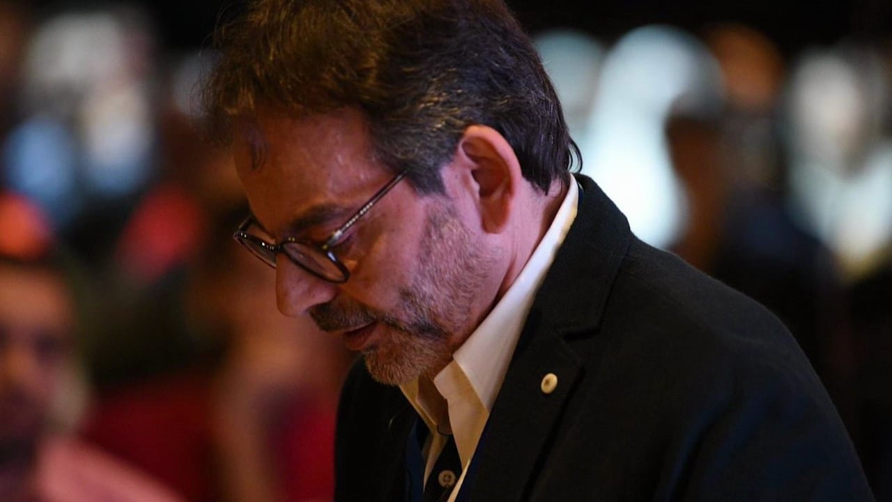 A speaker in profile, in low light, during EDSIC 2026.