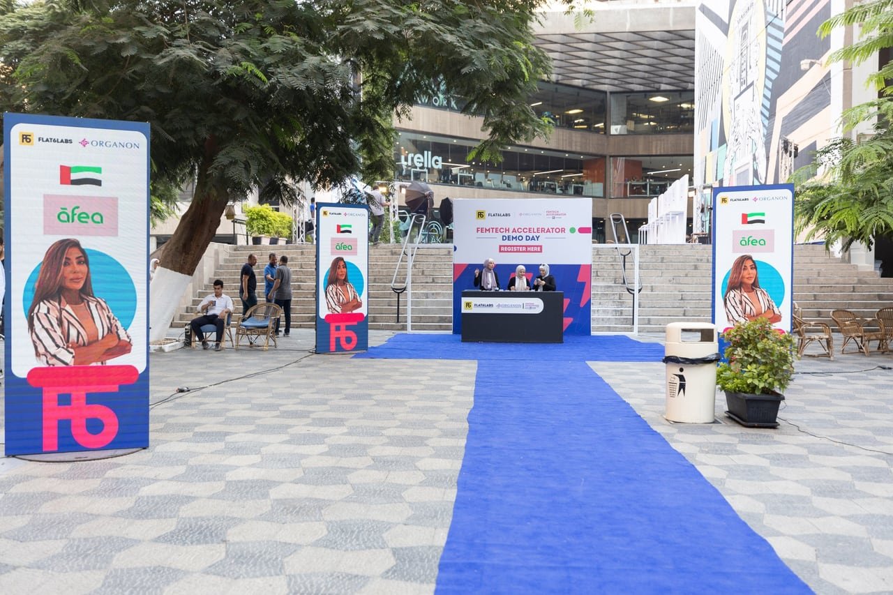 The entrance, with accelerator banners on both sides of the blue carpet.