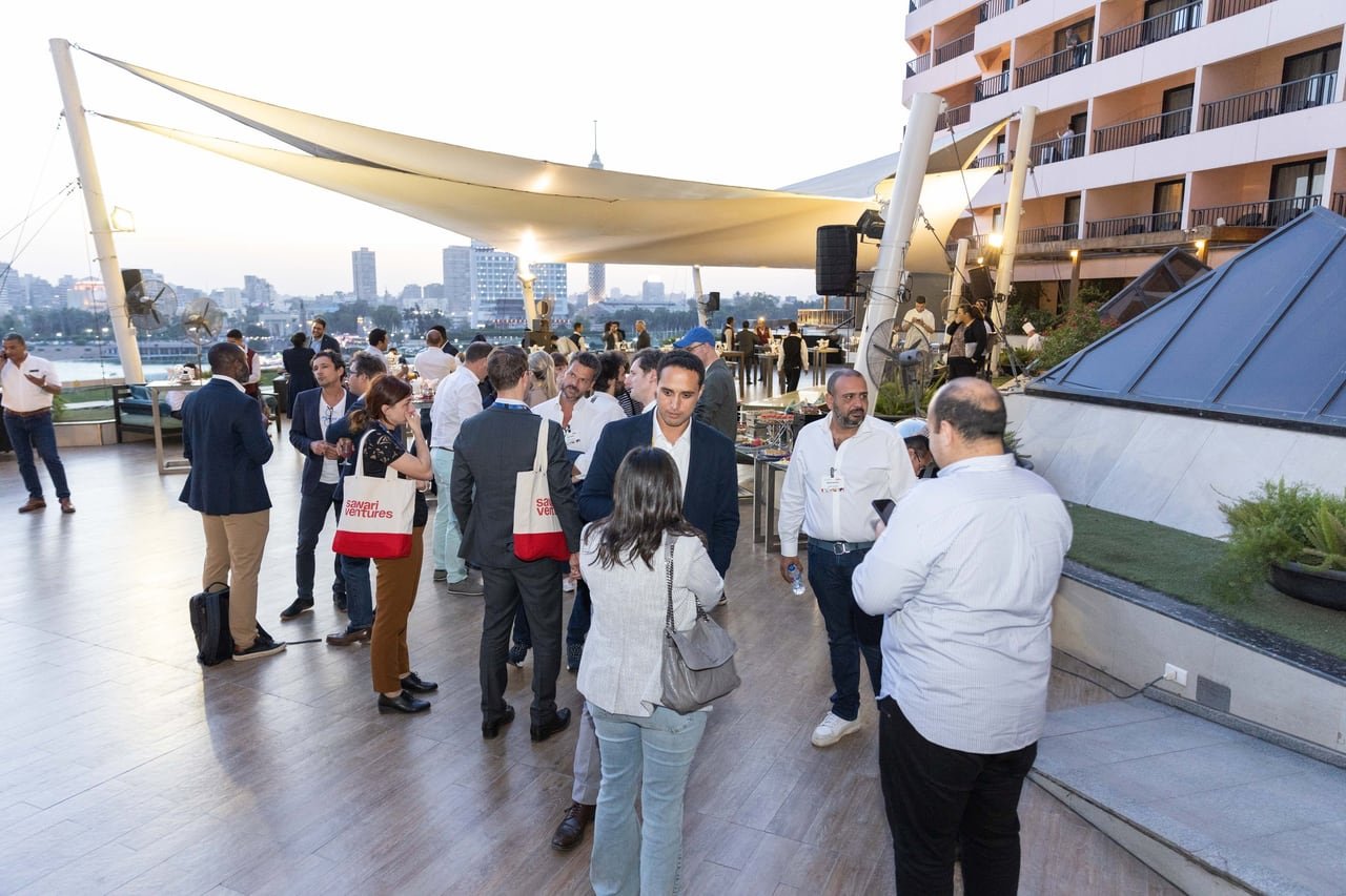 Guests on the rooftop at sunset, the Nile behind them.