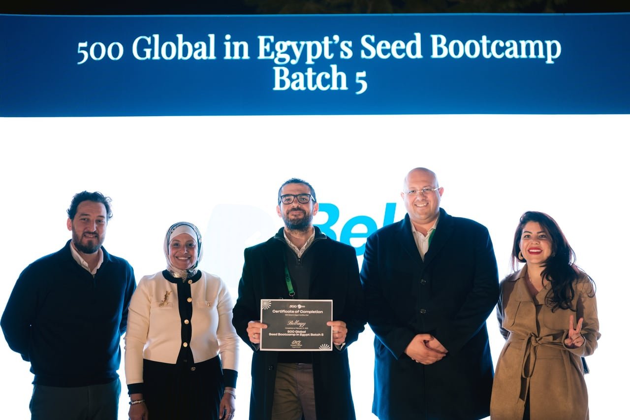 A startup team receiving its certificate on stage.