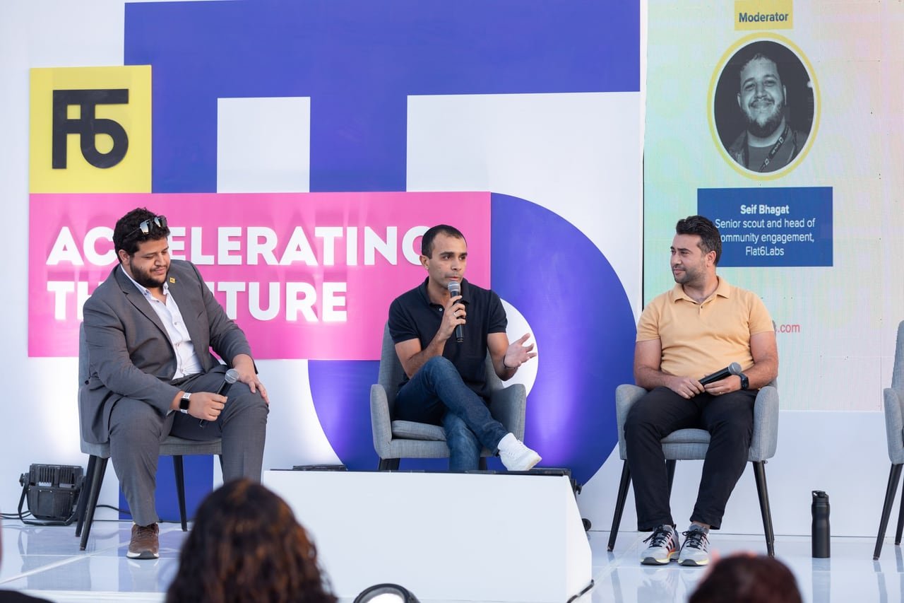 A three-person panel on stage.