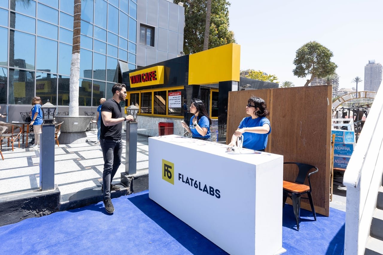 The registration team behind the Flat6Labs desk on the blue carpet at the dock.