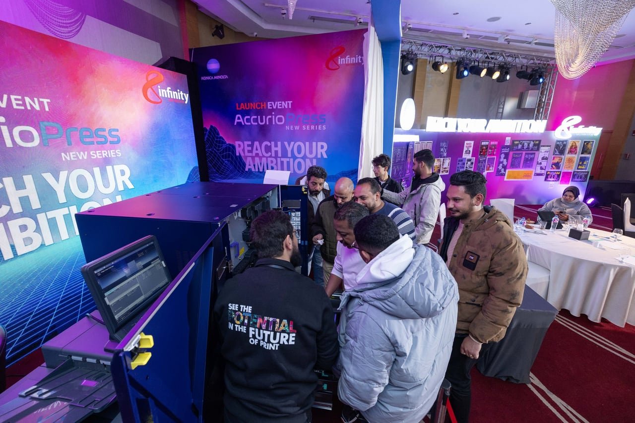 Guests gathered around the press during a live demo.