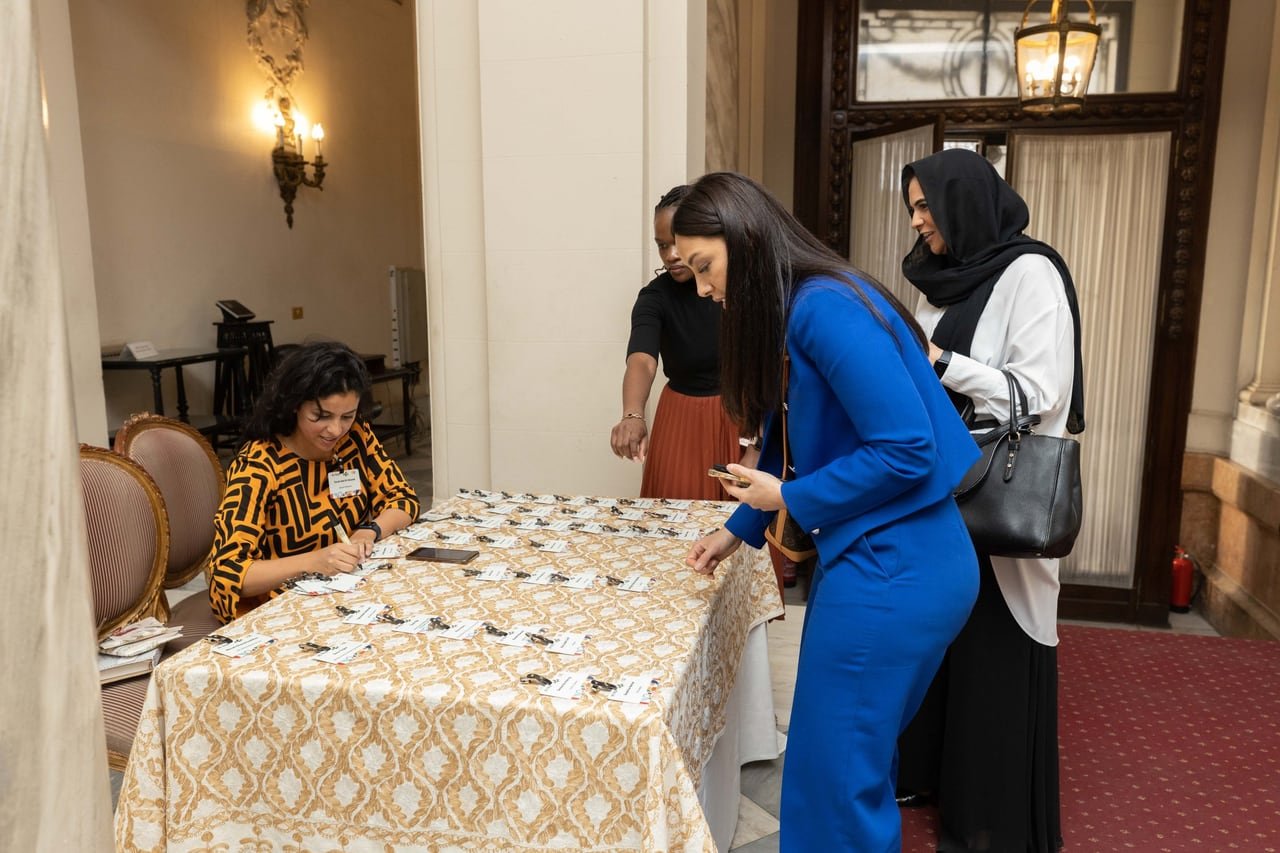 Guests at the registration table by the hall entrance.