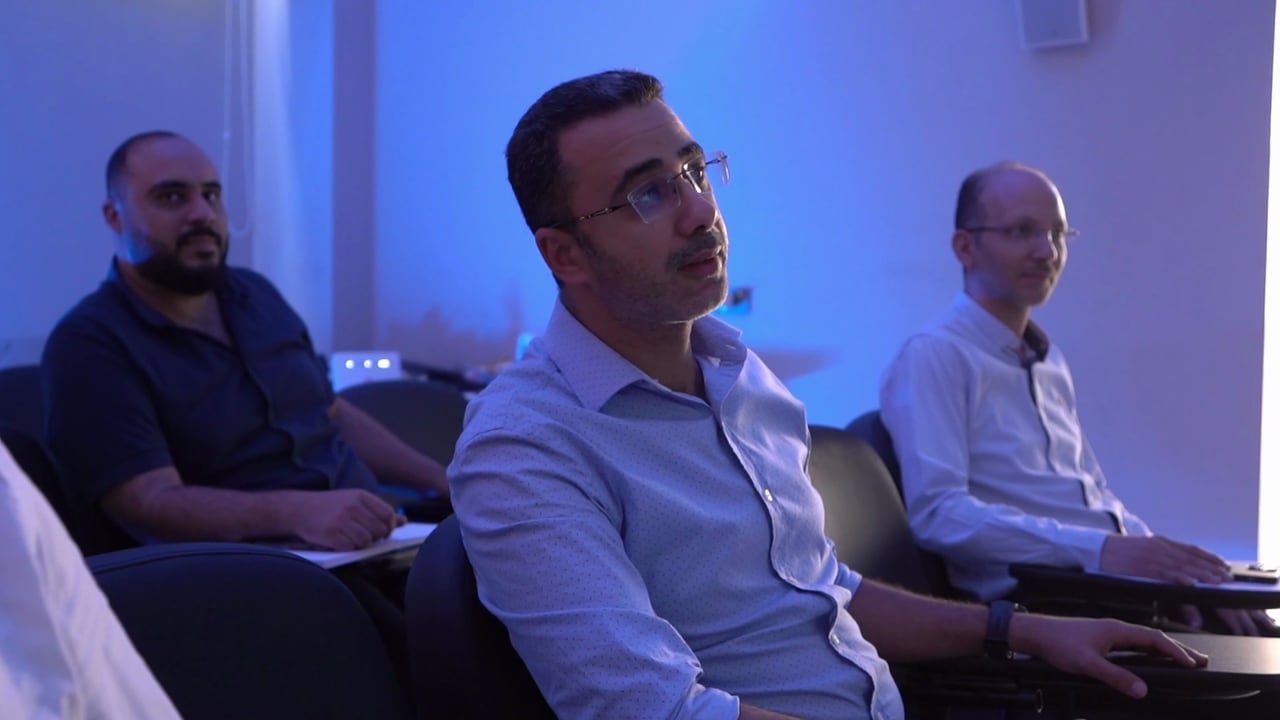 Managers listening during a meeting.