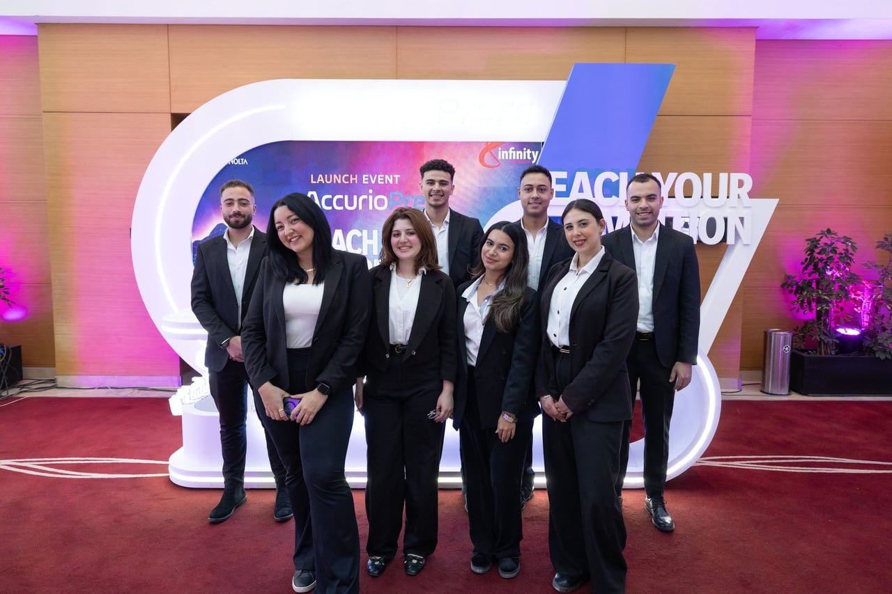 The hosts team in front of the Reach Your Ambition set.