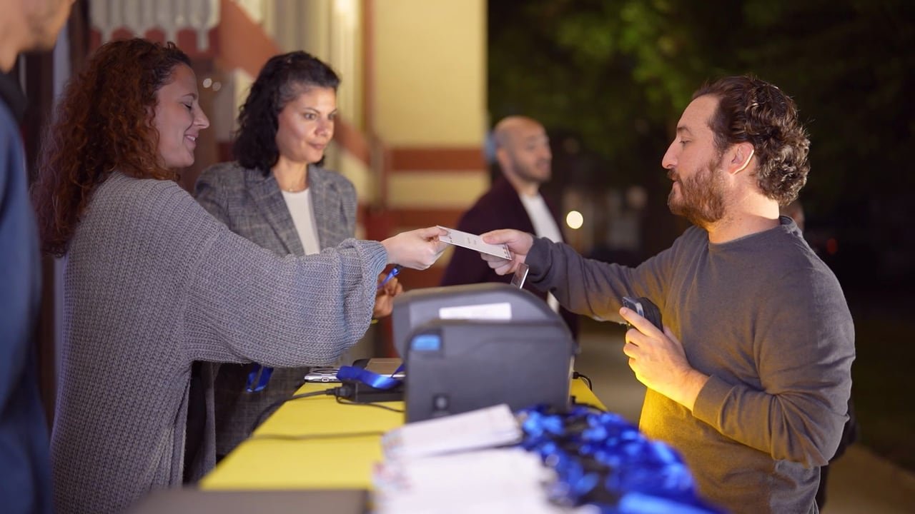Guests collecting badges at registration.
