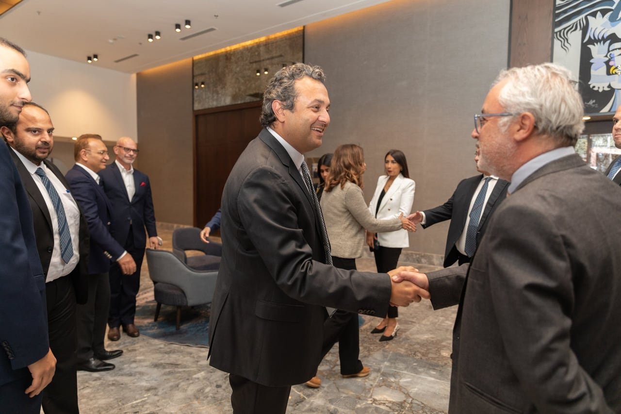 A handshake between guests after the signing.