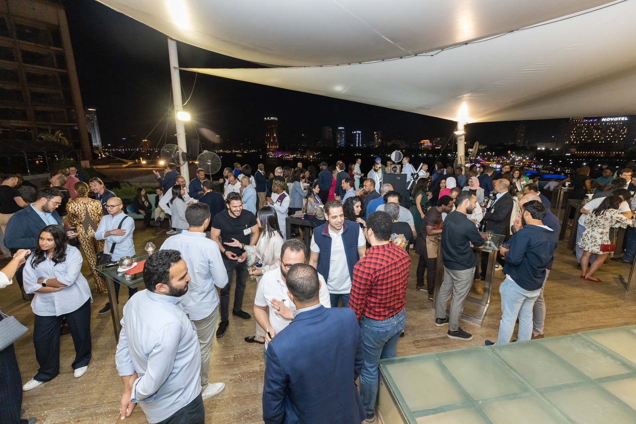 The evening after dark, the rooftop full.