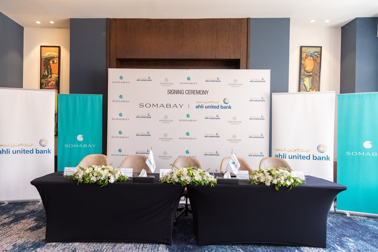 The signing table with the Ahli United Bank and Somabay logos before the ceremony.