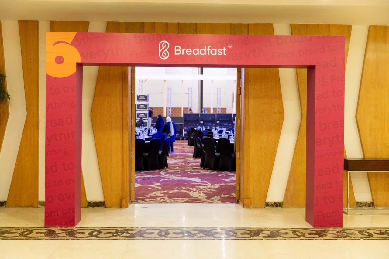 Breadfast's red entrance gate with the number 6, leading into the ballroom.